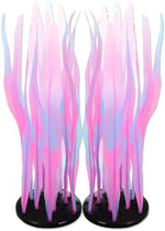 Fluorescent silicone fish tank decorations glowing vividly under blue aquarium lighting