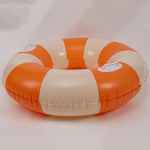Adults relaxing on inflatable beach lounge floats