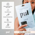 Close up of charcoal infused twin floss system on a plant based dental stick.