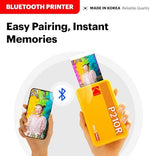 Kodak 4PASS wireless mobile printer alongside thirty eight sheets bundle pack on a table
