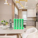 Close up view of four individual green and silver triple A one point two volt rechargeable cells