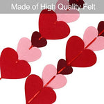 Adjustable burgundy and pink felt hearts spaced out evenly on a hanging string garland for anniversary decoration