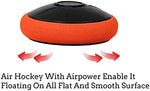 Two red plastic air hockey strikers showing the soft protective felt bottoms for scratch-free tabletop gaming.