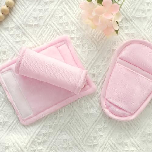 Soft pink shoulder pads attached to baby stroller harness