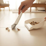 Brush and dustpan set snapped together showing the hanging storage hole.