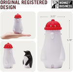 White and red bear shaped fridge odor eliminator placed on a refrigerator shelf.