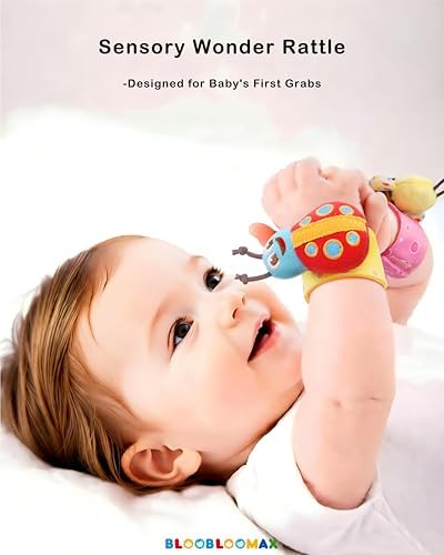 Infant wearing colorful Bloobloomax wrist rattles and ankle socks in a car seat.