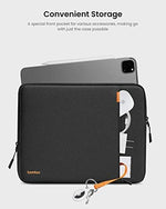 Tomtoc slim profile travel sleeve held naturally alongside a modern backpack