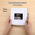 Close up of the ultrasound photo opening on the white pregnancy keepsake sign