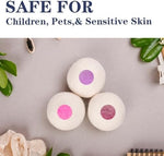 Extra large organic wool laundry balls next to a clean stack of family clothing