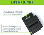 Dual USB camera battery charger with two Wasabi Power batteries inserted and charging indicators visible.