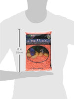 Estes Permaglo orange gravel pouring into a glass aquarium