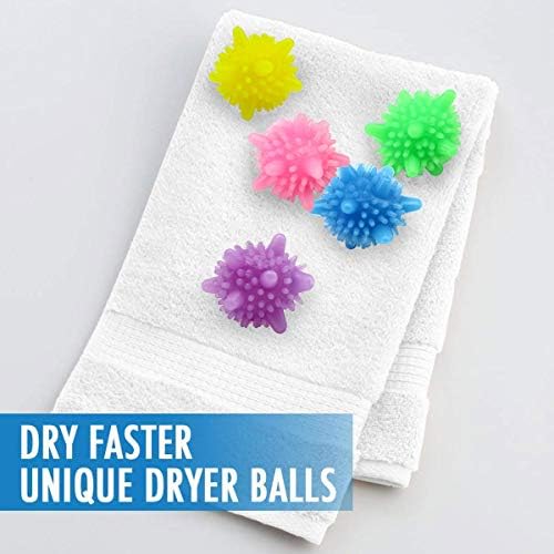 Eco-friendly laundry balls being placed into a washing machine drum with clothes.
