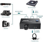 YGiTK audio preamplifier showcasing simultaneous connection to both RCA cables and a three point five millimeter headphone cable.