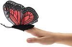 Side view of Folkmanis butterfly finger toy on a hand demonstrating the wing fluttering movement.