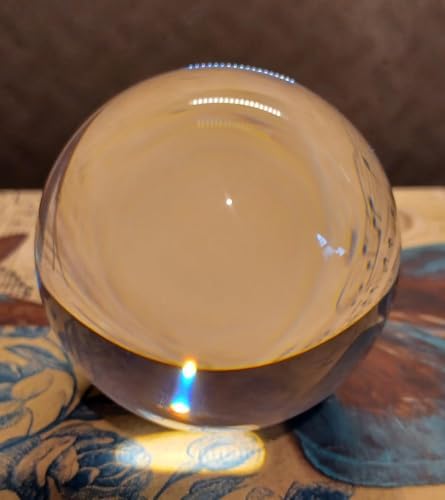 Side angle view of the transparent 70mm manipulation sphere highlighting the flawless hand-polished surface finish.