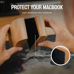 An elegant MacBook Pro stored vertically inside the solid walnut wood laptop stand to save desk space.