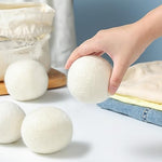 Comparison of New Zealand wool dryer balls next to standard laundry.