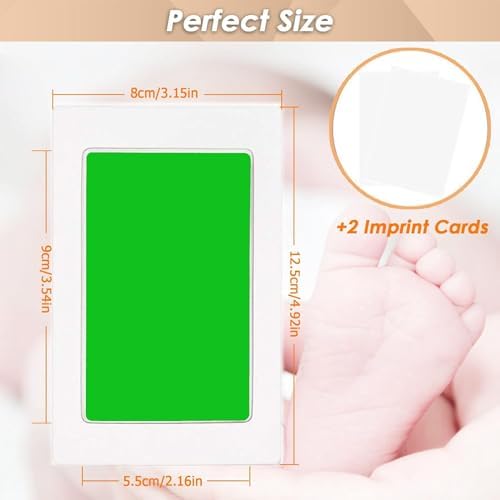 Newborn baby hand pressing on a green clean touch inkless pad for mess free memory keeping.