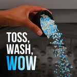 Downy Unstopables Fusions laundry scent beads container next to freshly washed fabrics illustrating long lasting fabric freshness.