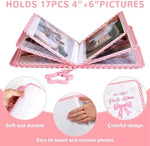 ZOIIWA pink bow infant photo album highlighting the attached star shaped teether toy