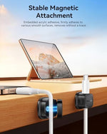 Black adjustable magnetic cord holder holding phone charger wire close up view