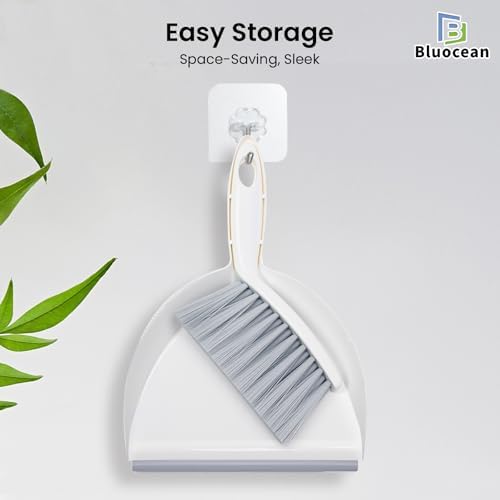 Small cleaning brush snapping into dustpan for storage