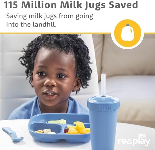 Toddler enjoying a meal on a Re-Play divided plate
