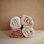 Close up look of the breathable cotton texture on the Mushie Fog changing pad cover
