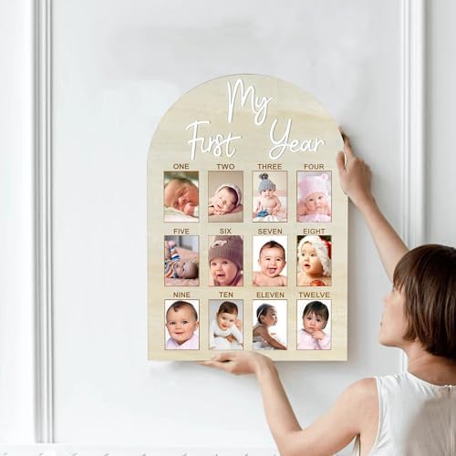 Baby first year photo display board showcasing twelve month photo slots on a nursery wall.