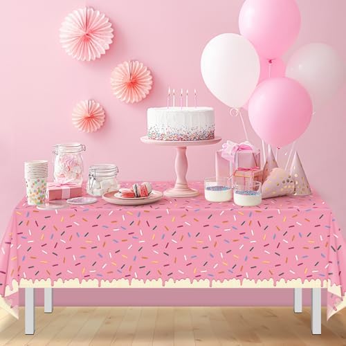 Waterproof plastic tablecloth protecting a wooden table from bright pink spills