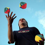 A user safely holding multiple URATOT beginner colorful juggling balls to demonstrate size proportions and proper training grip.