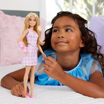 Close up view of the blonde hair and doodle detailed pink arm cast on Barbie 243