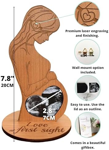 Heart's Sign sonogram frame standing on a nursery table holding a baby scan picture.