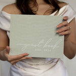 Open wedding guest book showing lined and blank pages