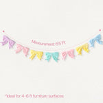 Close up view of the ultra soft pink and pastel plush fabric bows on the spring decoration banner.