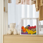 Two white Holay storage bins displayed side by side on a modern playroom shelf for kids block storage.