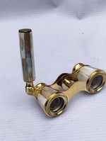 Top angle view of the twenty-five millimeter glass objective lenses and polished brass framing of the Victorian binoculars.
