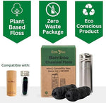 Two rolls of black bamboo charcoal floss refills next to a steel dispenser.
