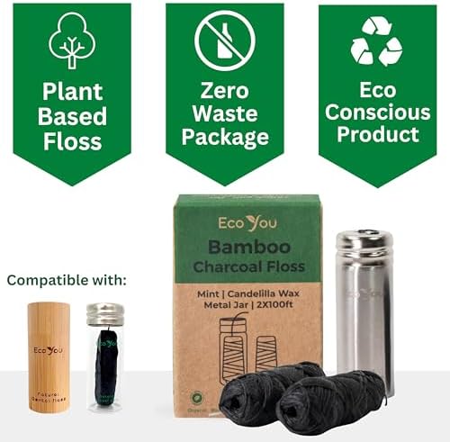 Two rolls of black bamboo charcoal floss refills next to a steel dispenser.