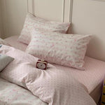 Matching envelope closure pillowcases arranged neatly next to the princess style floral bedding setup.