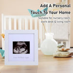 Square six point nine inch baby announcement frame styled on a nursery tabletop