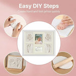 White wooden newborn keepsake frame displayed on a nursery tabletop beside baby accessories