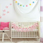 Bridal shower venue setup featuring premium pink ribbon garland banners on a dessert table