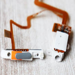 Close up view of the replacement hold switch mechanism on the silver thin ribbon cable assembly.