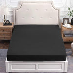 Pure Era black fitted sheet neatly placed on a king bed