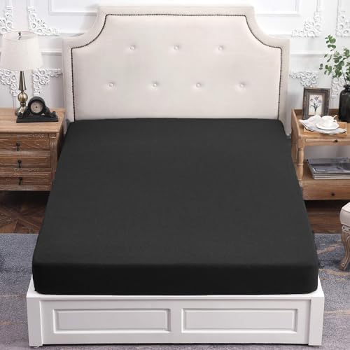 Pure Era black fitted sheet neatly placed on a king bed