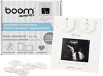 Grey and silver wood sonography photo frame placed on a living room side table.