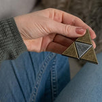 Elegant Hanayama Zelda collectible puzzle displayed on a modern office desk setup.