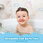 Toddler holding a chunky blue hexagon bathtub crayon drawing smoothly on a wet white porcelain wall.
